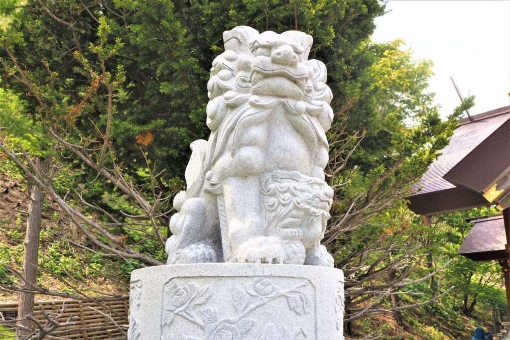 北門神社の境内に鎮座する、子をしっかりと母が抱きかかえた親子狛犬