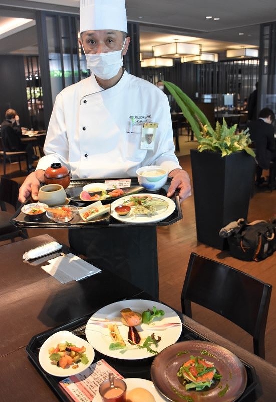 和食メニューを手にする藤田伸幸総料理長。手前は洋食メニュー