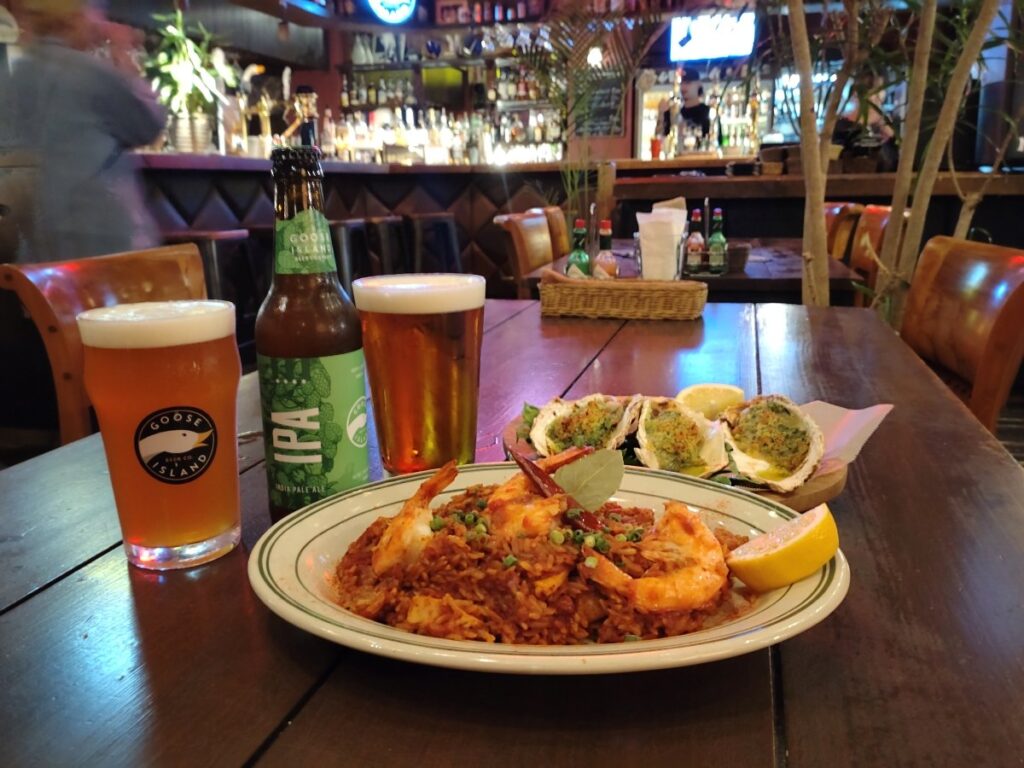 店オリジナルのクラフトビール「ディックス　no5」（右）とグースＩＰＡ、看板メニューのジャンバラヤ（手前）、カキ料理