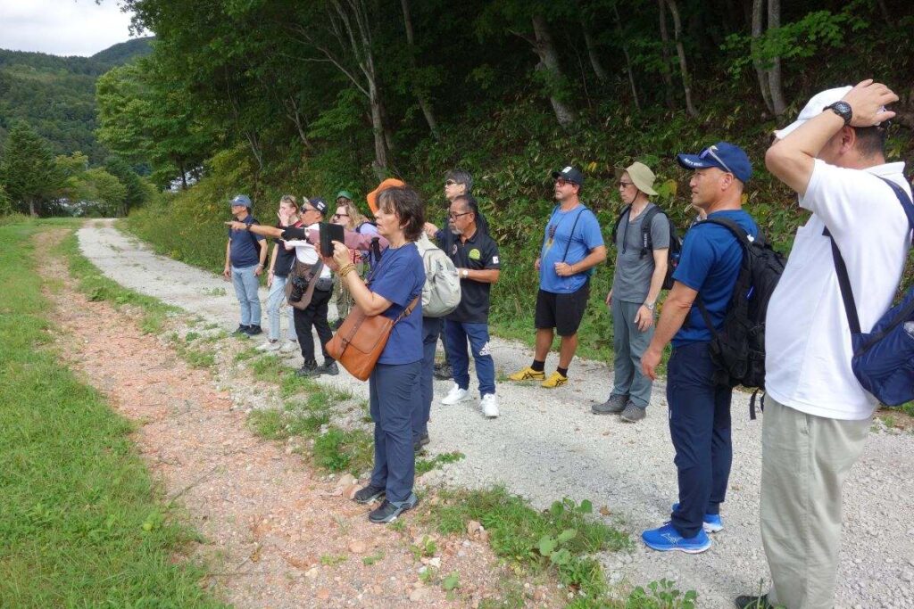 夕張の歴史や産業ゆかりの場所でガイドの話に耳を傾ける参加者