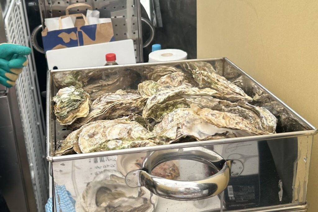 「牡蠣の羅ストラーダ」で湯気の立つ蒸し器にぎっしり詰まった知内のカキ