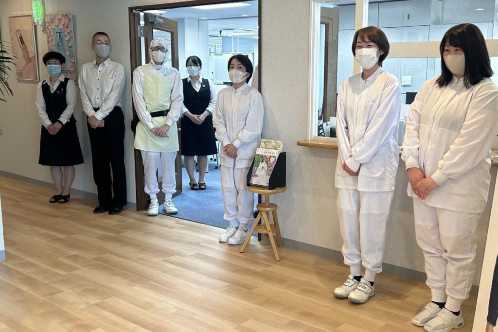 見学者を出迎える従業員